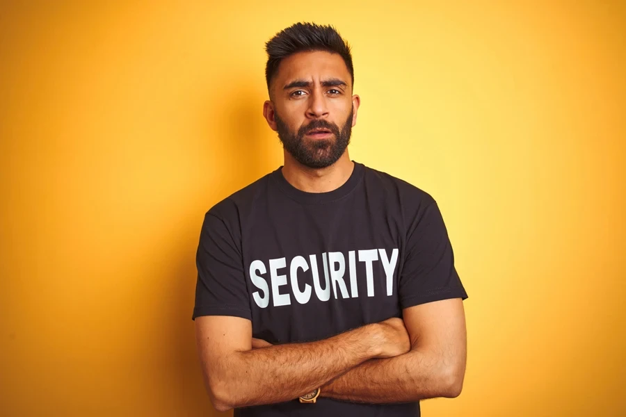 A man wearing a branded work T-shirt