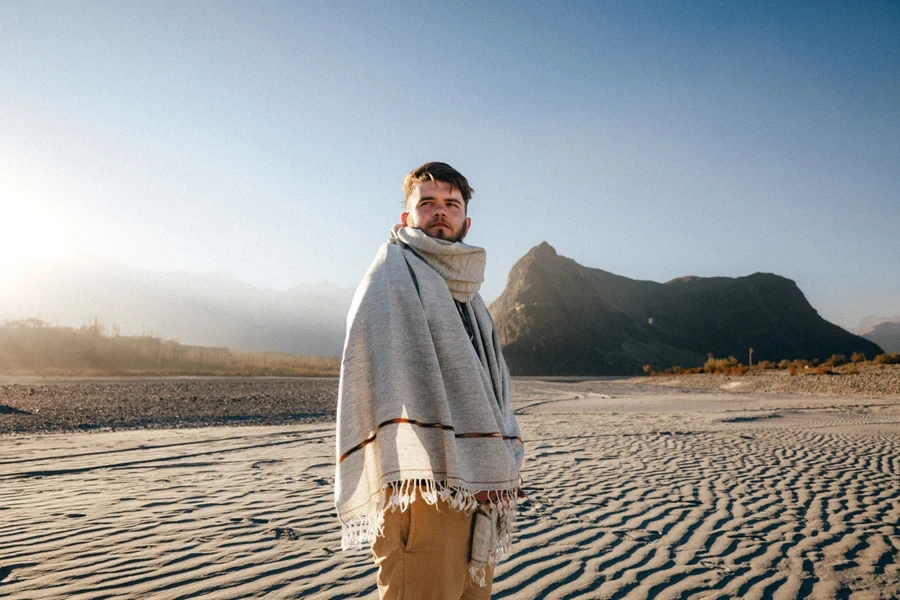 A man wearing a nomadic cape layer