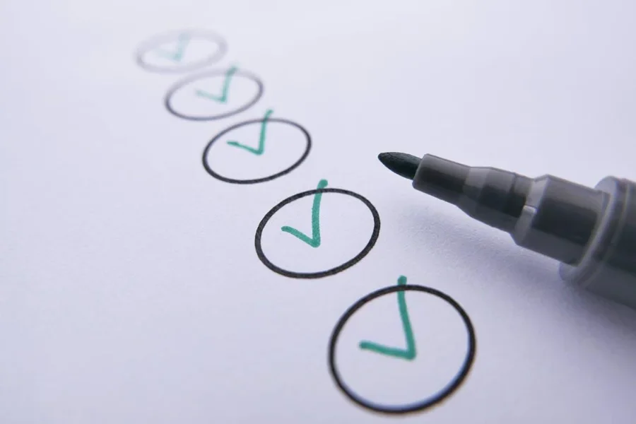 A marker near checked circles on white paper