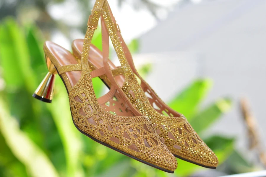 A pair of beautiful gold slingback mules embellished with beads
