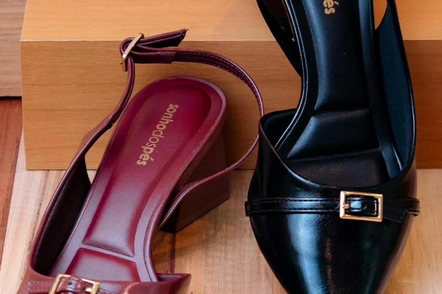 A pair of leather slingback mules on a wooden surface