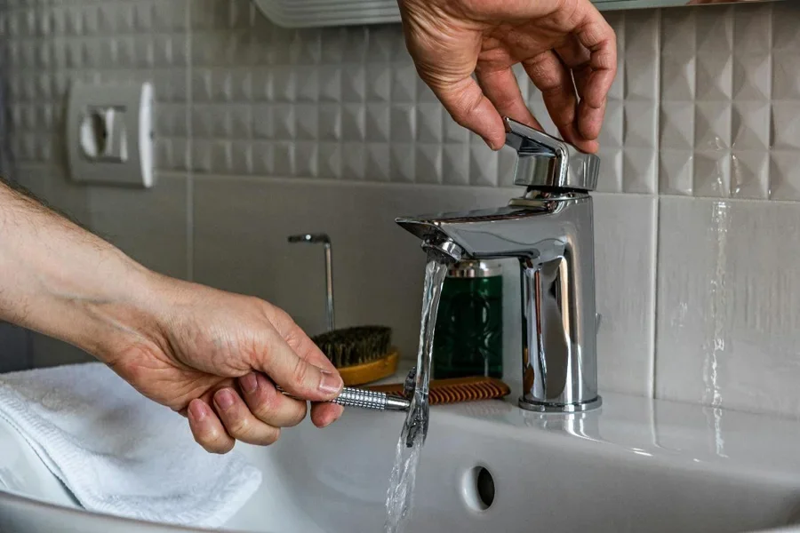 A person's hands filling a faucet with water