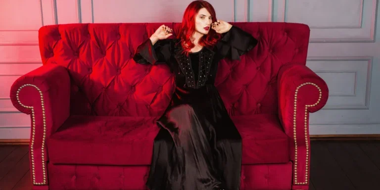 A red-headed goth wearing a gothic dress