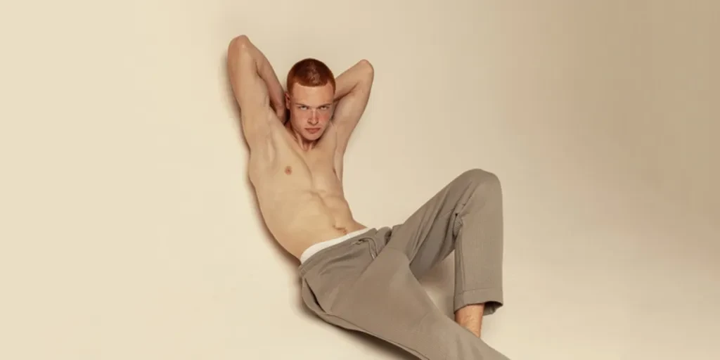 A shirtless man wearing sweatpants
