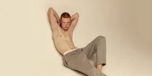 A shirtless man wearing sweatpants