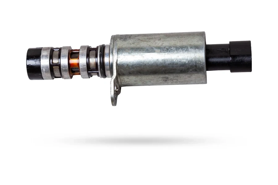 A side view of a VVT solenoid on a white background