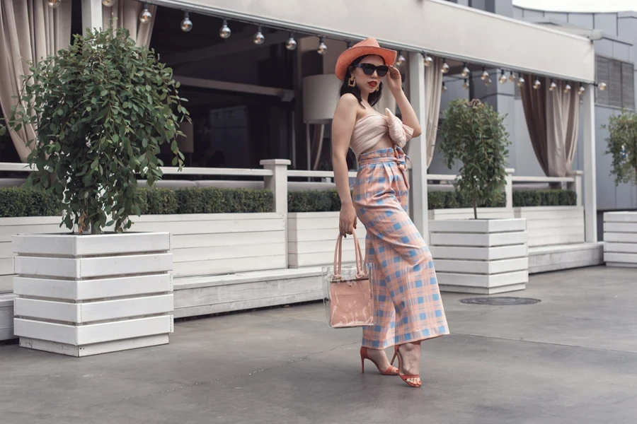 A young lady posing in retro high-waisted trousers