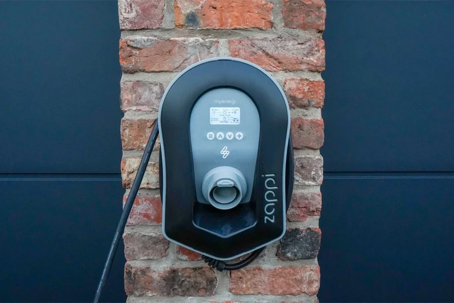 An EV home charger mounted on a brick wall