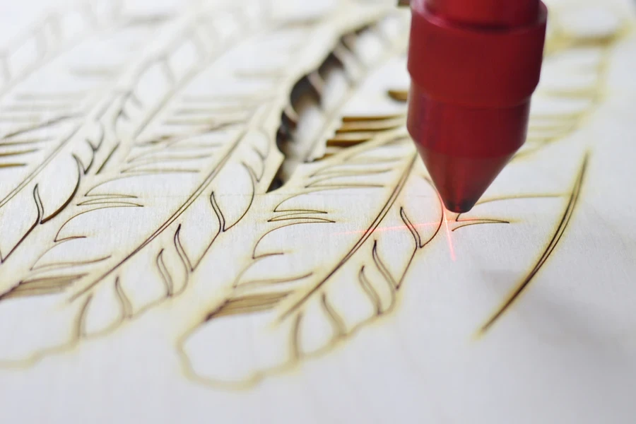 An etching machine engraving feathers
