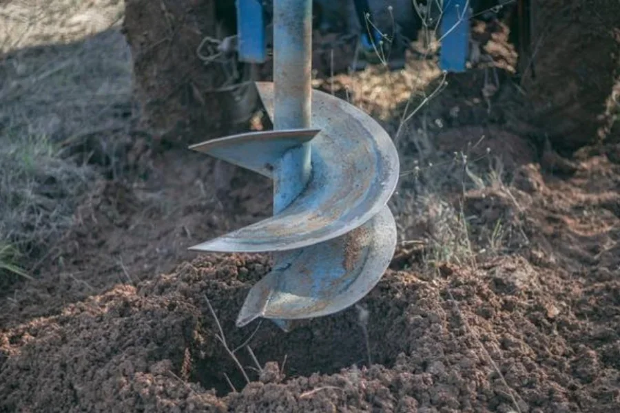 Auger for digging holes in the ground