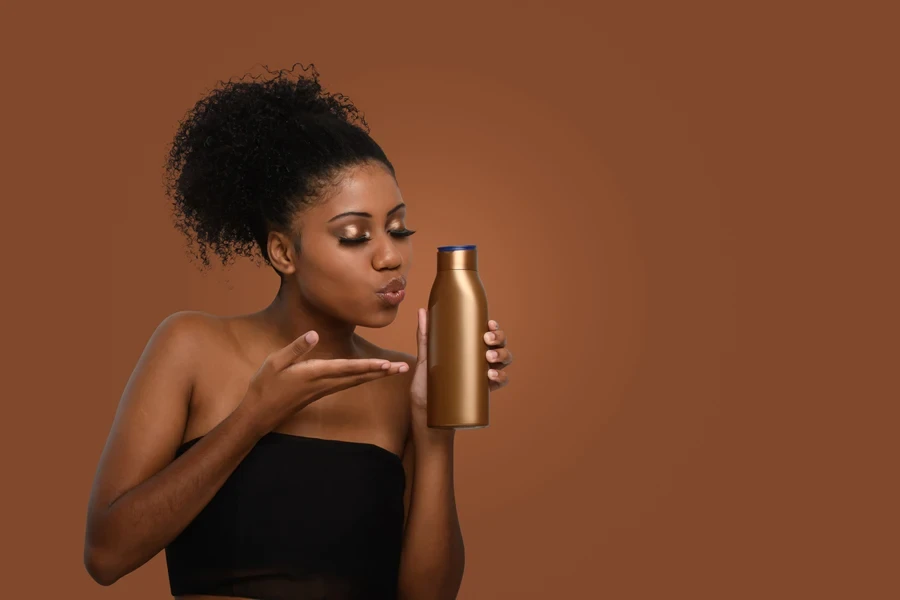 Black woman holding sulfate-free shampoo for hair strands