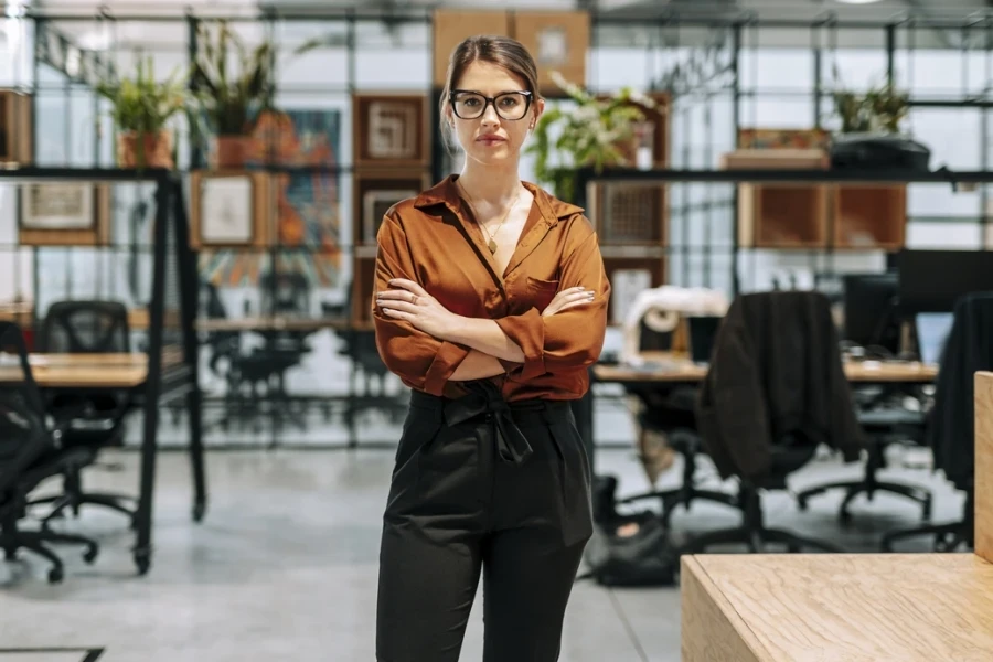 Businesswoman in a brown blouse and black drawstring pants
