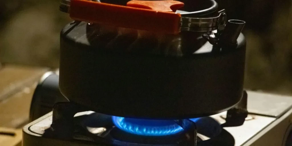 Camp stove product with blue flame and pot
