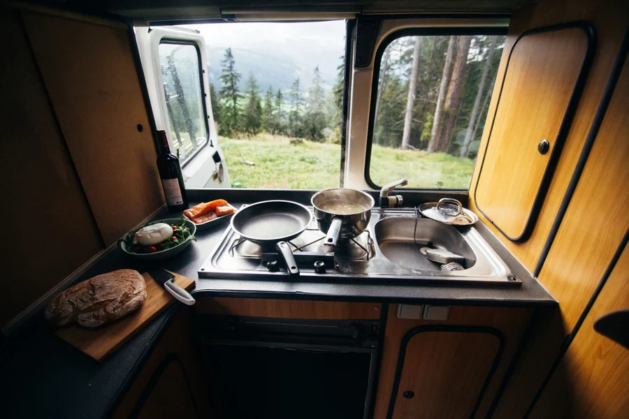 Camping van kitchen with pots and utensils