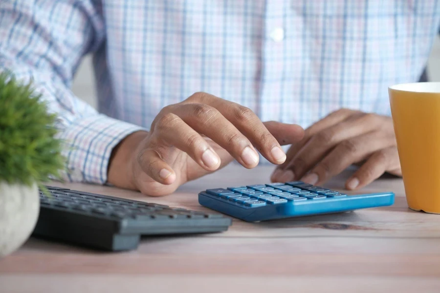 Close-up of a man’s hands using a calculator