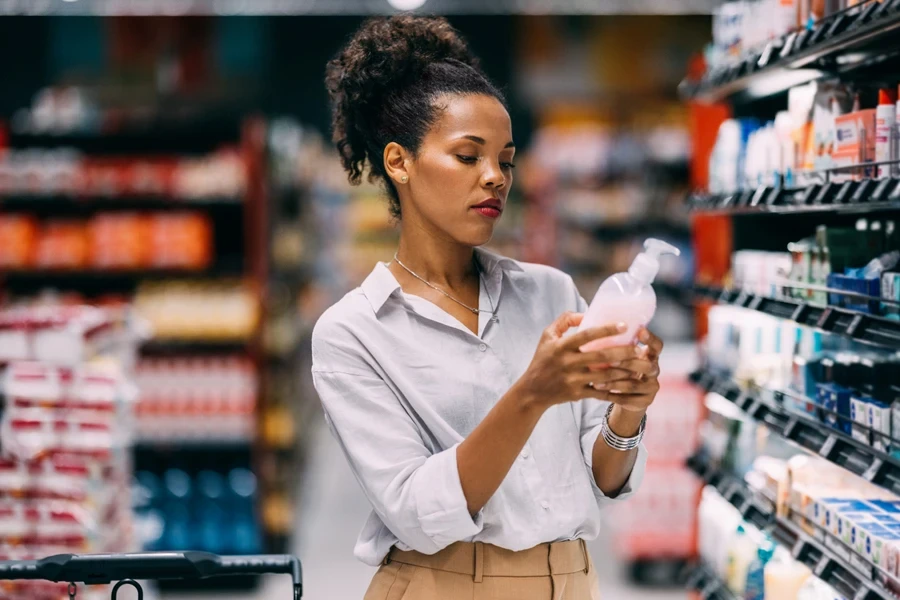 Female shopper with tight curls looking at hair care products