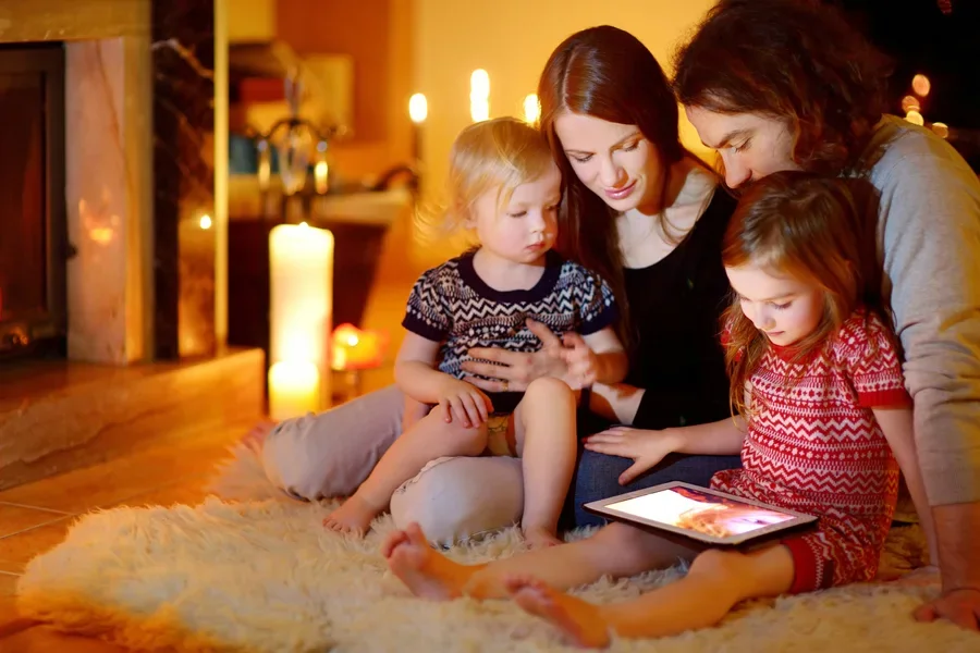 Happy family in a living room with burning candles