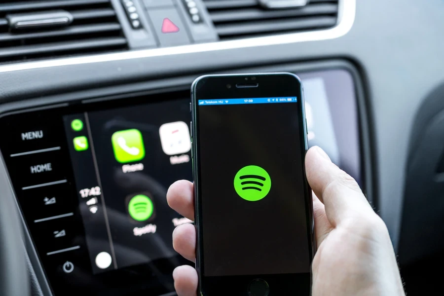 Man opening Spotify while connecting to CarPlay