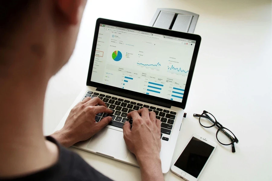 Man using a MacBook to calculate profitability