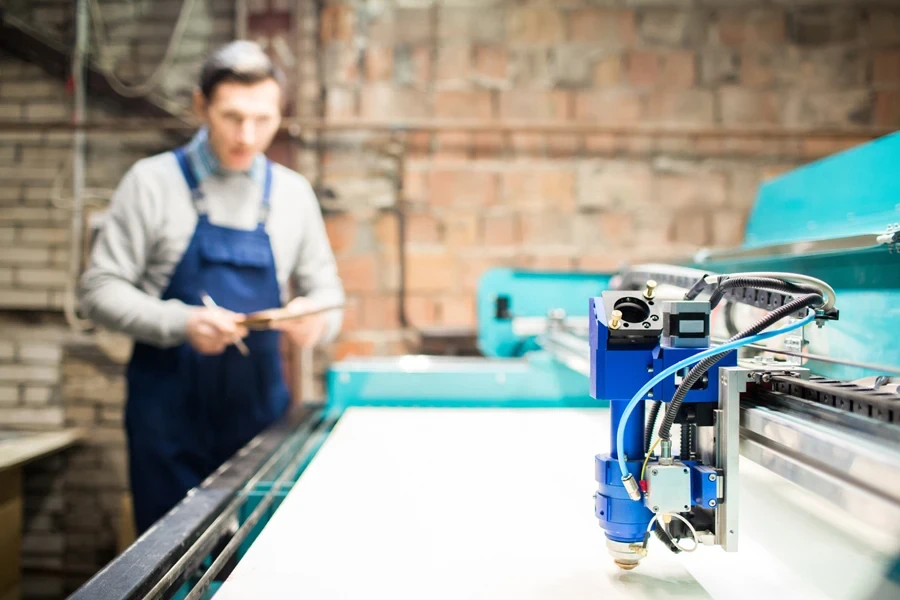 Man working with an etching machine