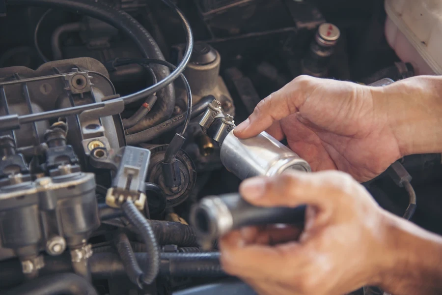 Mechanic attempting to replace a car's purge valve