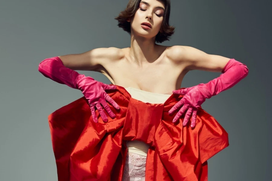 Model poses in a pink dress with a big bow