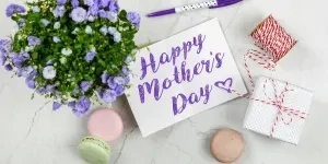 Mother’s Day card next to flowers and macarons
