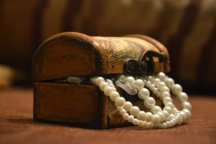 Pearl necklace inside a small treasure chest