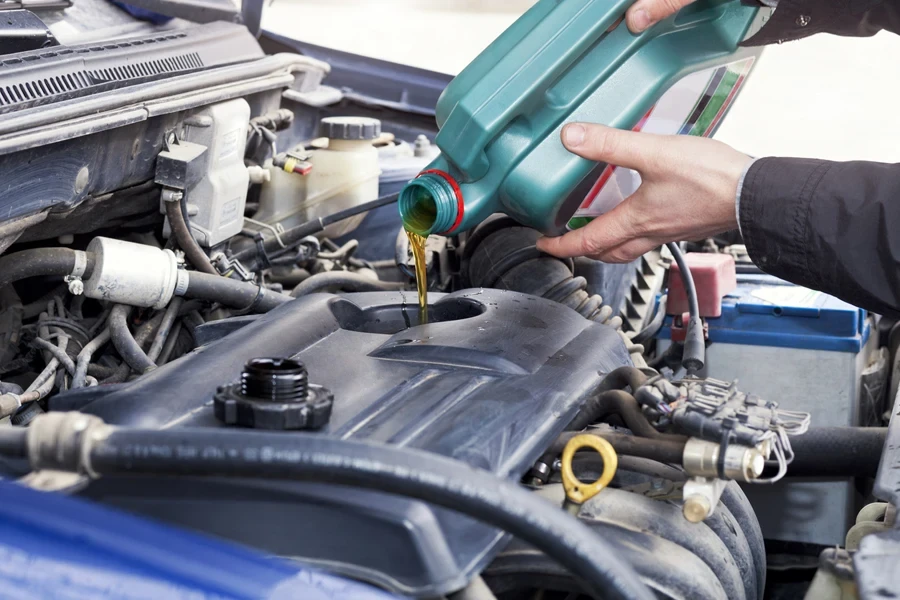 Person doing an oil change on their car