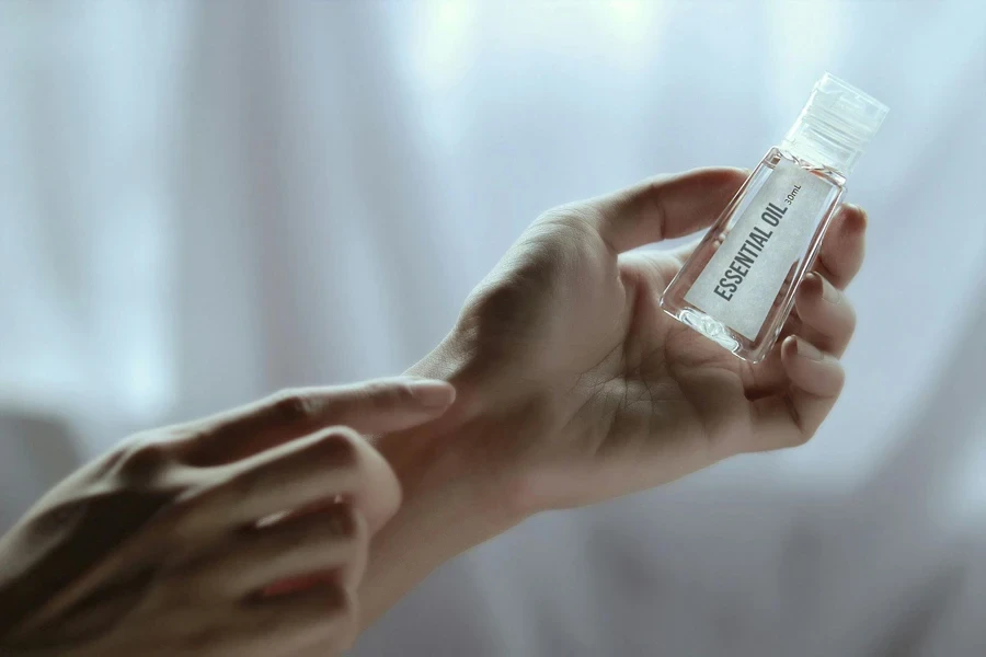 Person holding a bottle of essential oil