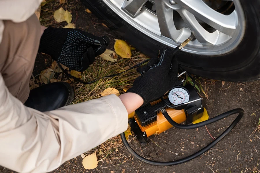 Person inflating tires with an inflator