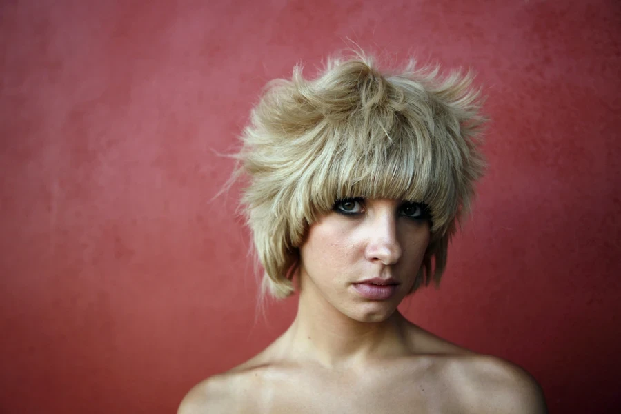 Portrait of woman with messy bixie cut with bangs