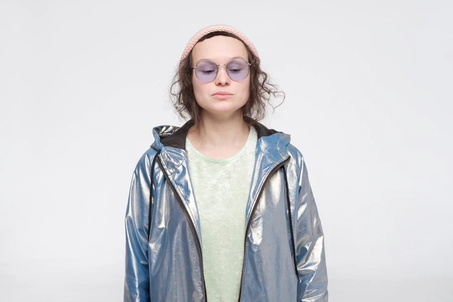 Pretty lady in shiny windbreaker and a t-shirt