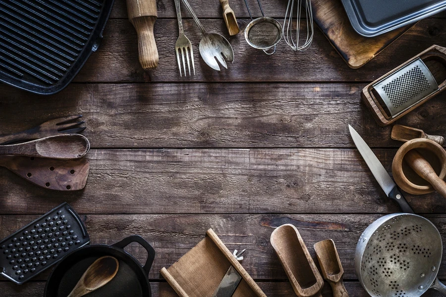 Selection of small kitchen items laid out on wooden table