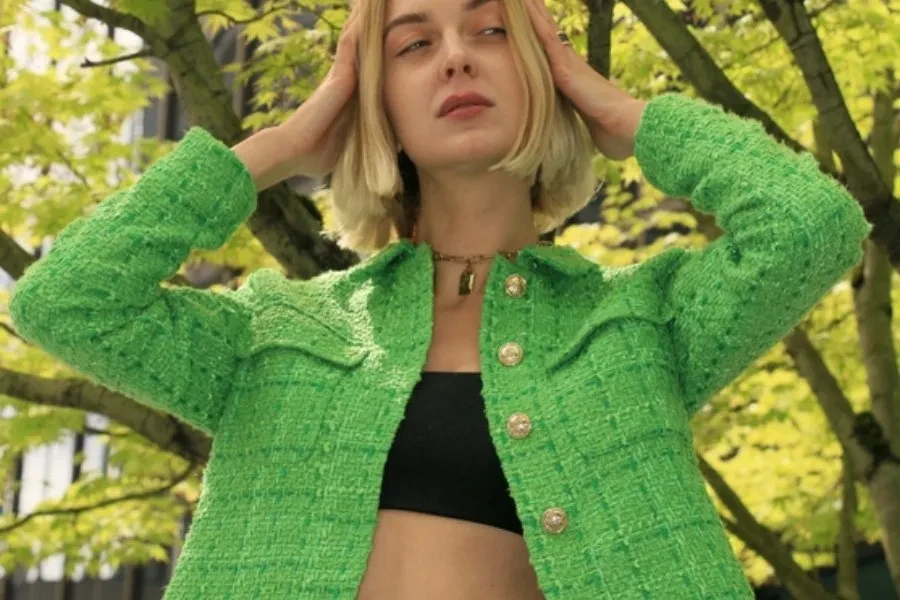Stylish woman in a green cropped jacket