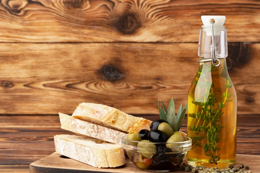 Transparent glass bottle with thyme and olive oil inside