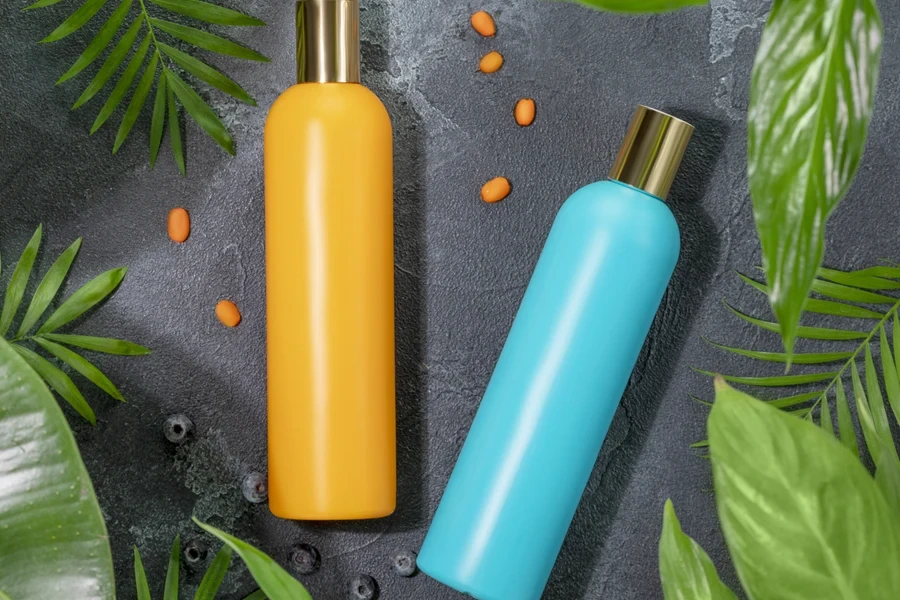 Two bottles of shampoo and conditioner on black countertop