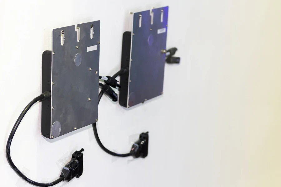 Two microinverters on a white wall