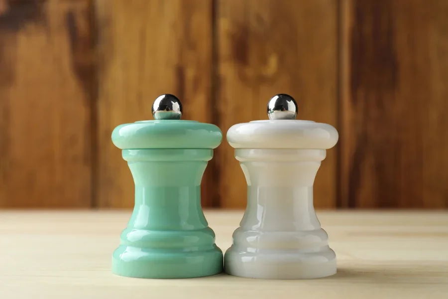 Two mini salt and pepper mills on table in bistro