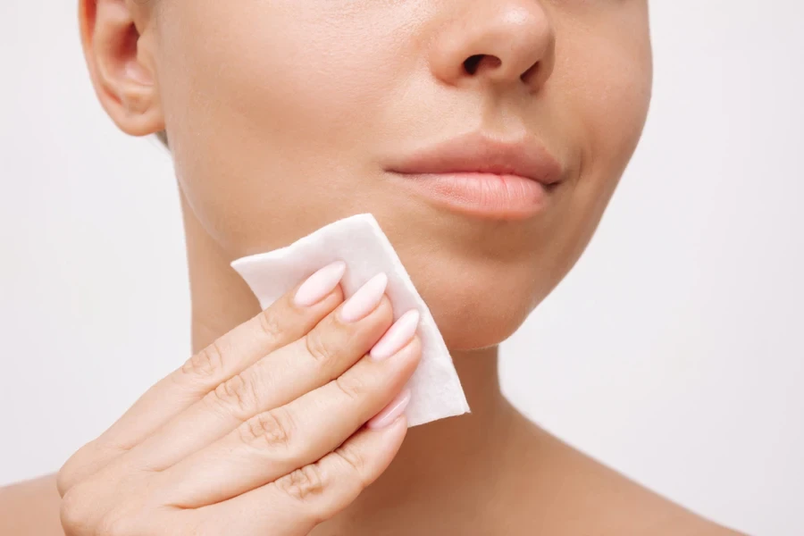 White cloth being used to clean face in bathroom
