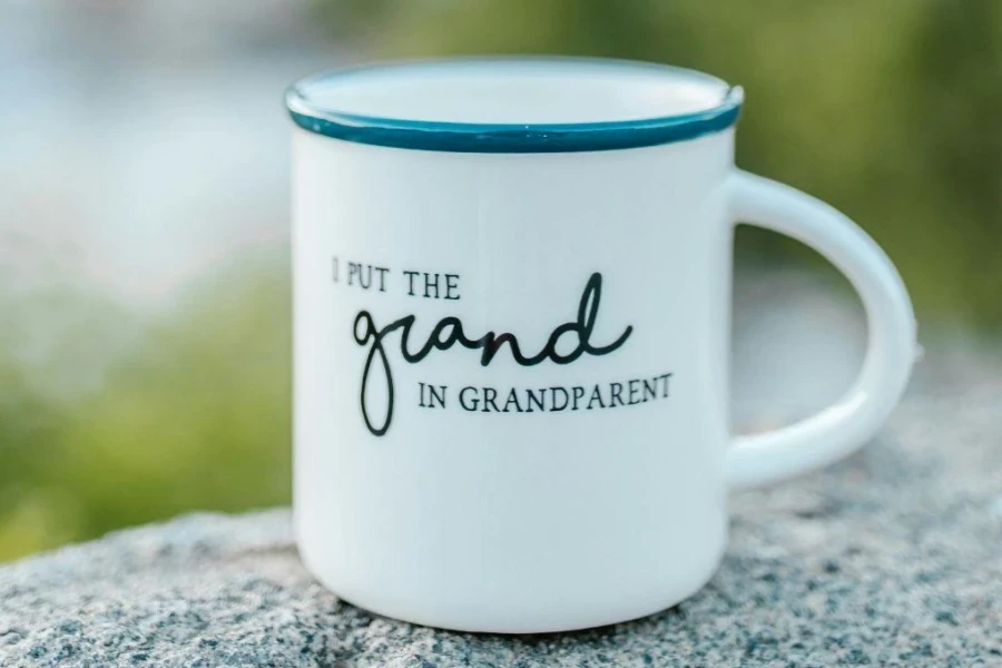 White mug for Grandpa placed on a rock