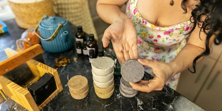 Woman holding shower steamer tablet with unique scent