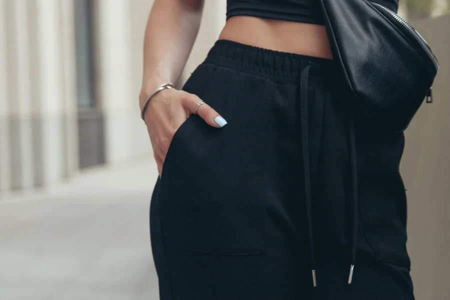Woman in elegant black crop top and drawstring pants