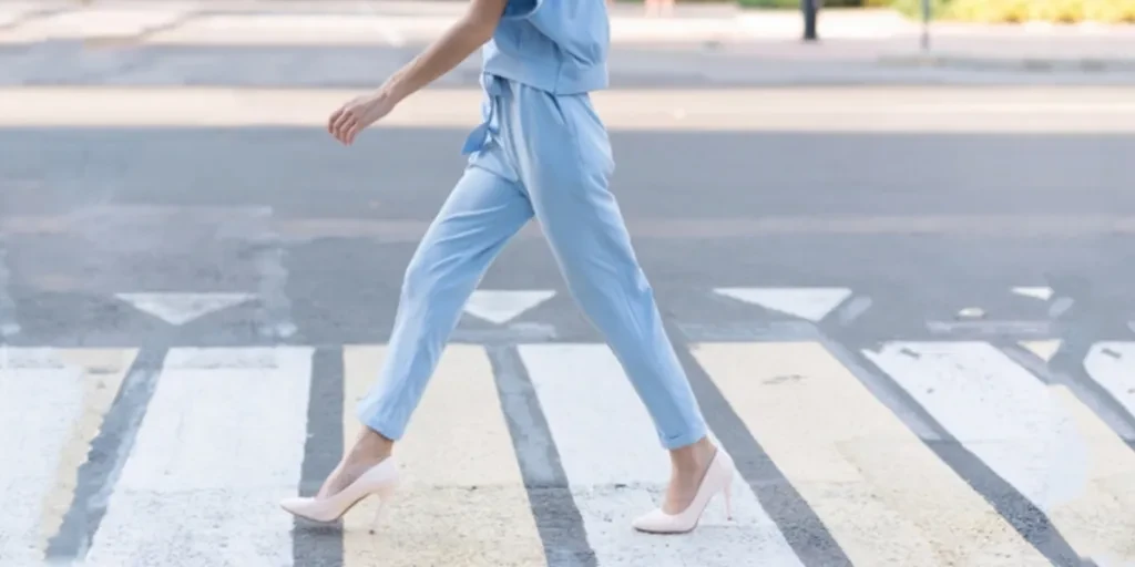 Woman in elegant blue drawstring pants and heels