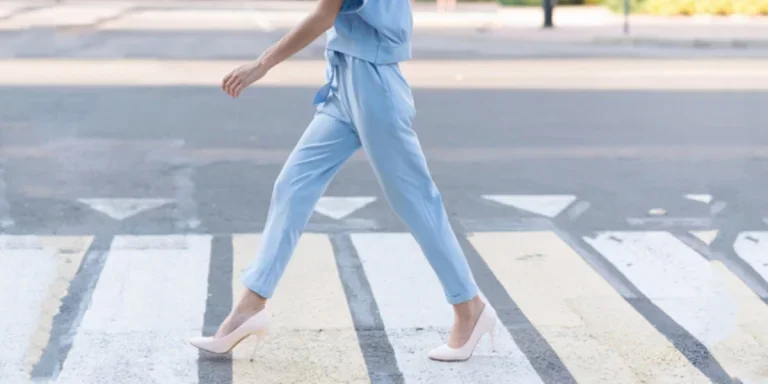 Woman in elegant blue drawstring pants and heels