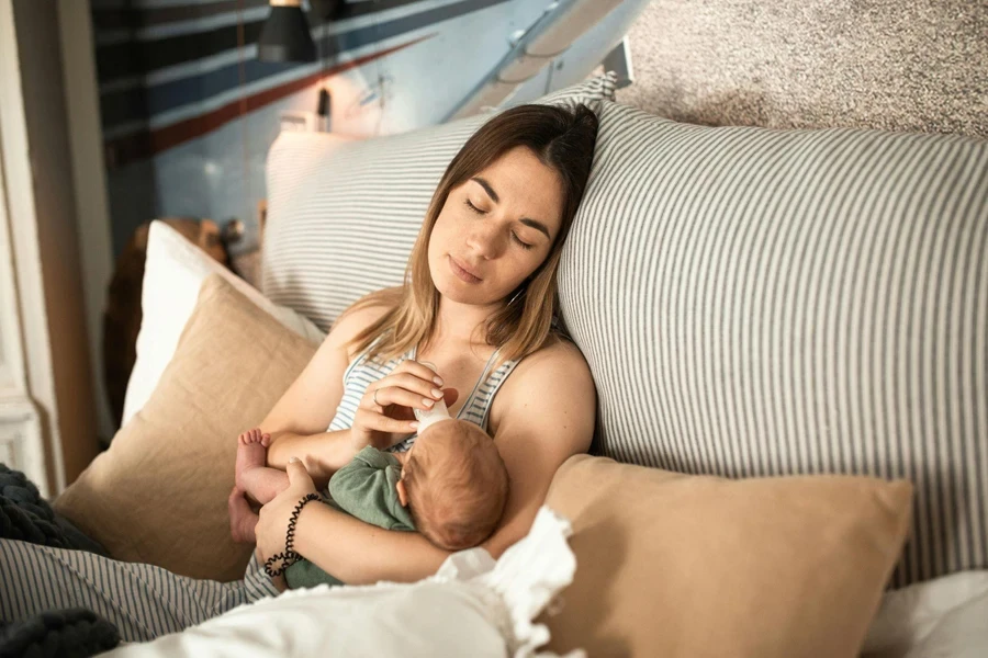 Woman nursing her baby while lying down