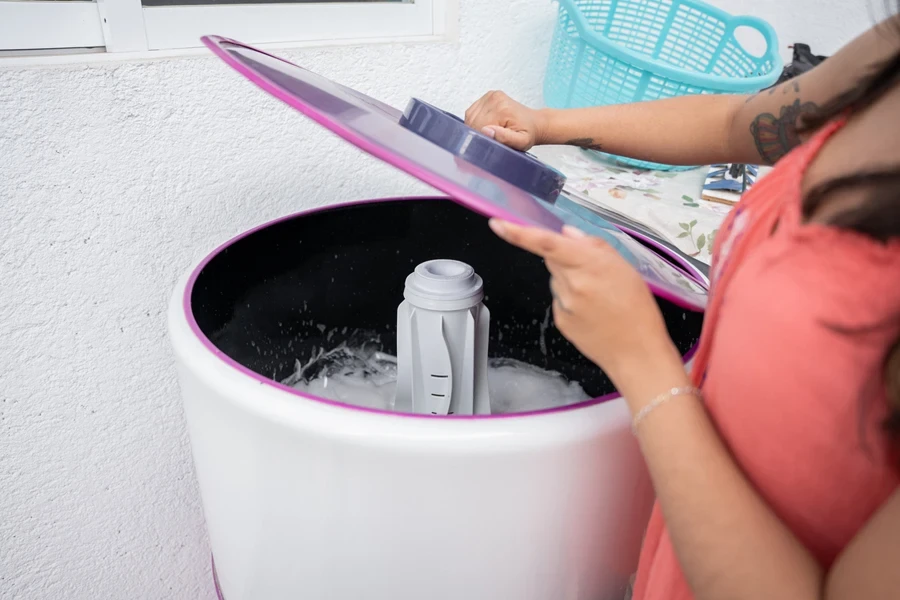 Woman opening a shoe-washing machine