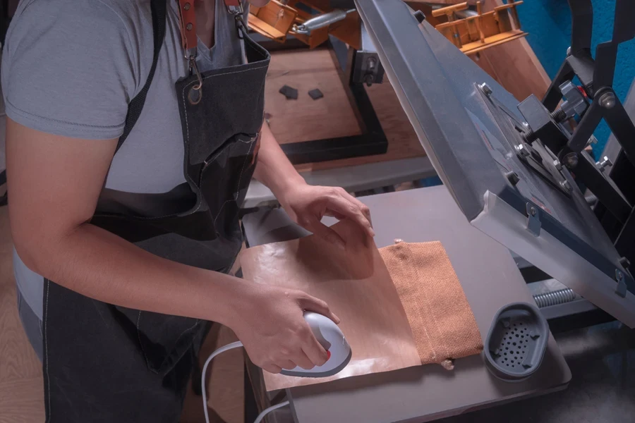 Woman using a white min heat press machine