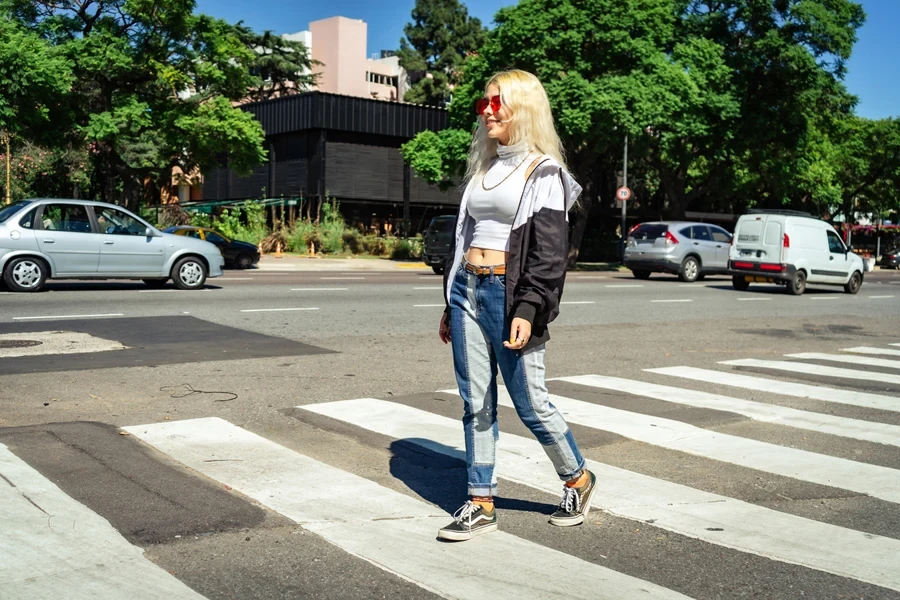 Woman wearing patchwork denim and a white crop top