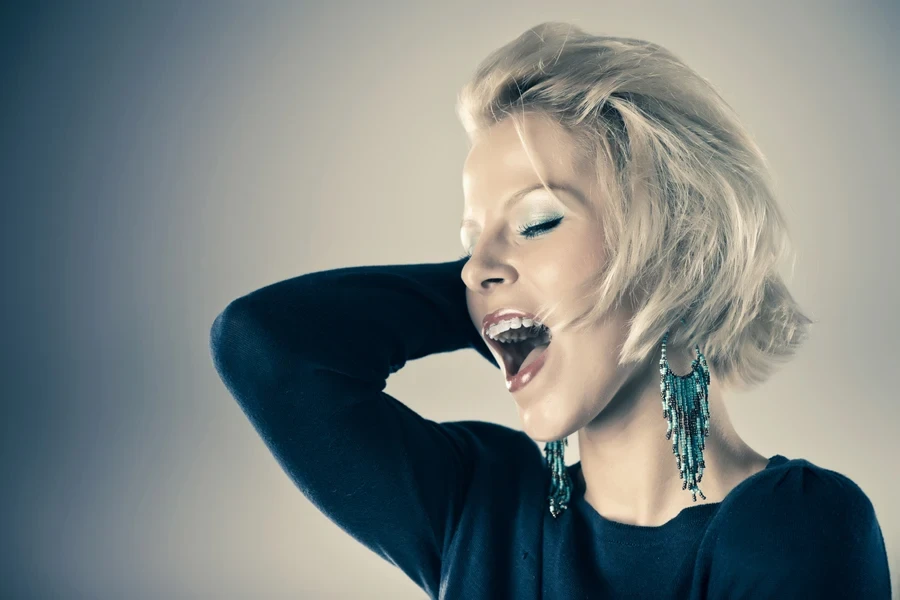 Woman with blond hair featuring a textured bixie cut